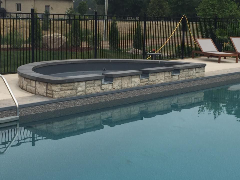 Installation of a stone tanning ledge on a pool